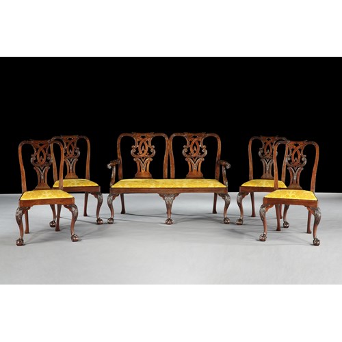A SUITE OF GEORGE II MAHOGANY SIDE CHAIRS WITH SETTEE